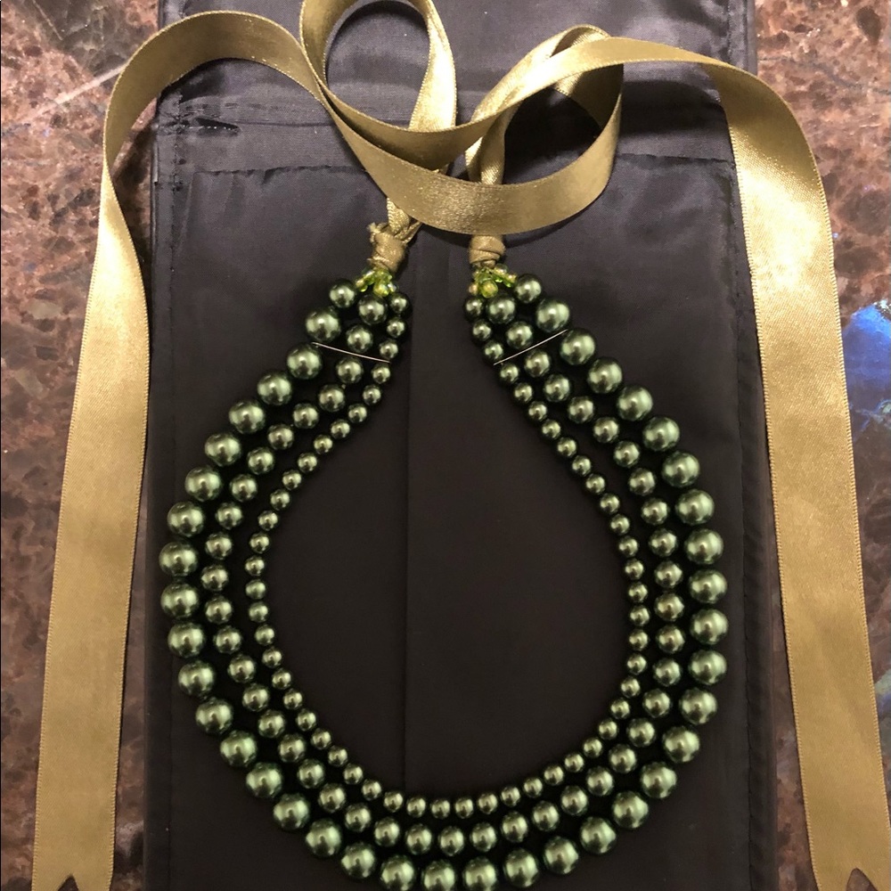 Green beaded necklace with ribbon tie.